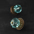 blue glass door knobs with bronze metal bases on a dark background