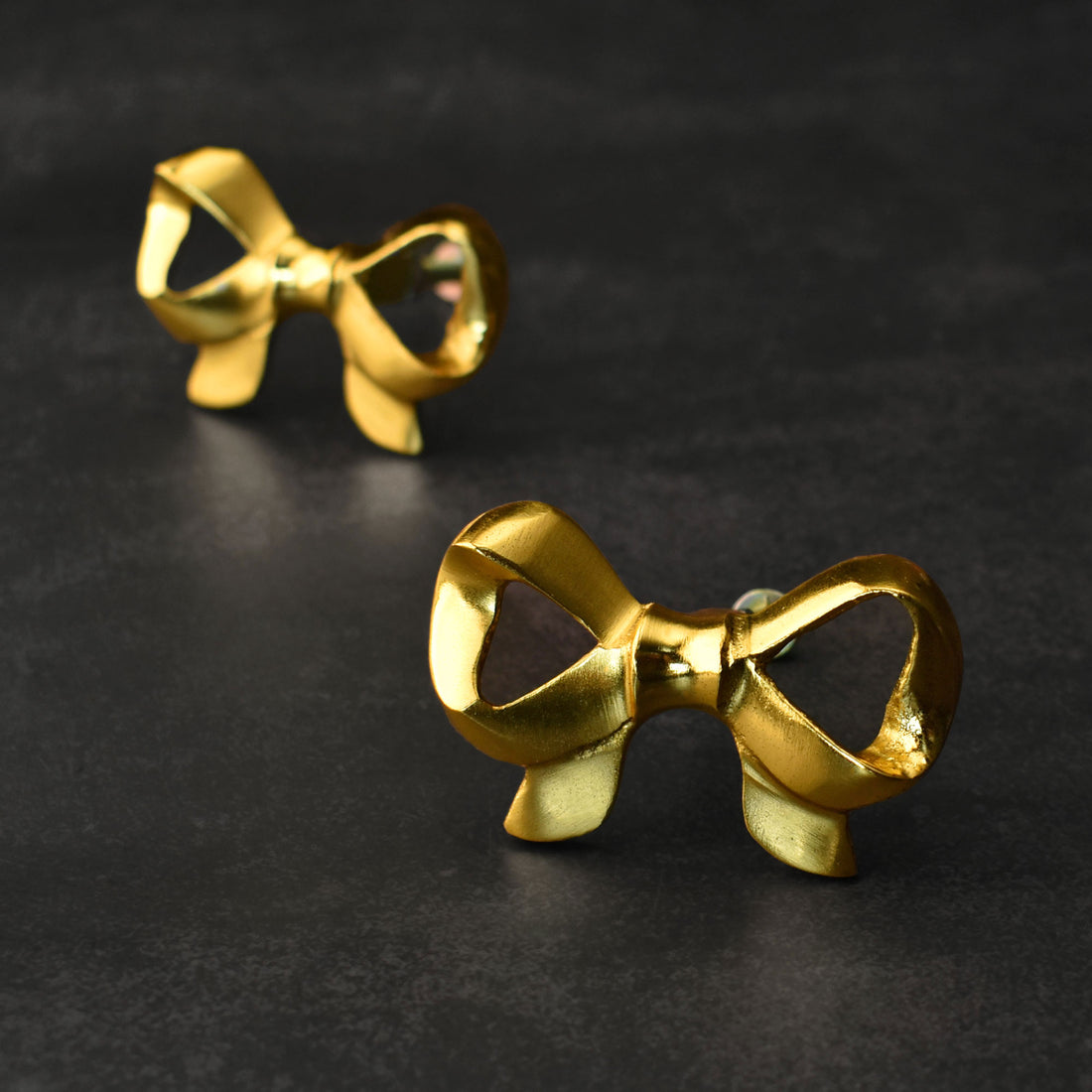 Gold bow-shaped knobs