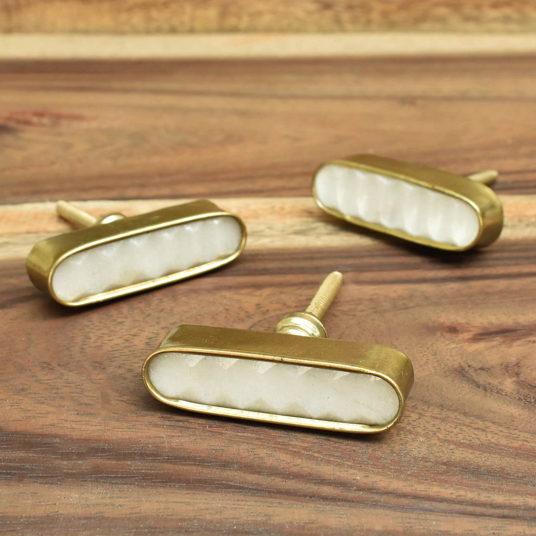 white stone and brass drawer knobs