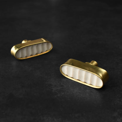 white stone and brass drawer knobs